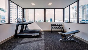A gym with treadmills, dumbbells, and a bench. - Triip Palago (Ho Chi Minh City)