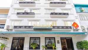 A hotel facade with balconies, a flag, and a sign reading "PALAGO HOTEL." - Triip Palago (Ho Chi Minh City)