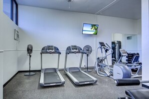 A gym with treadmills, a fan, and exercise equipment. - Resort Style, Heated Pool, Walk to Top Beach (Siesta Key)