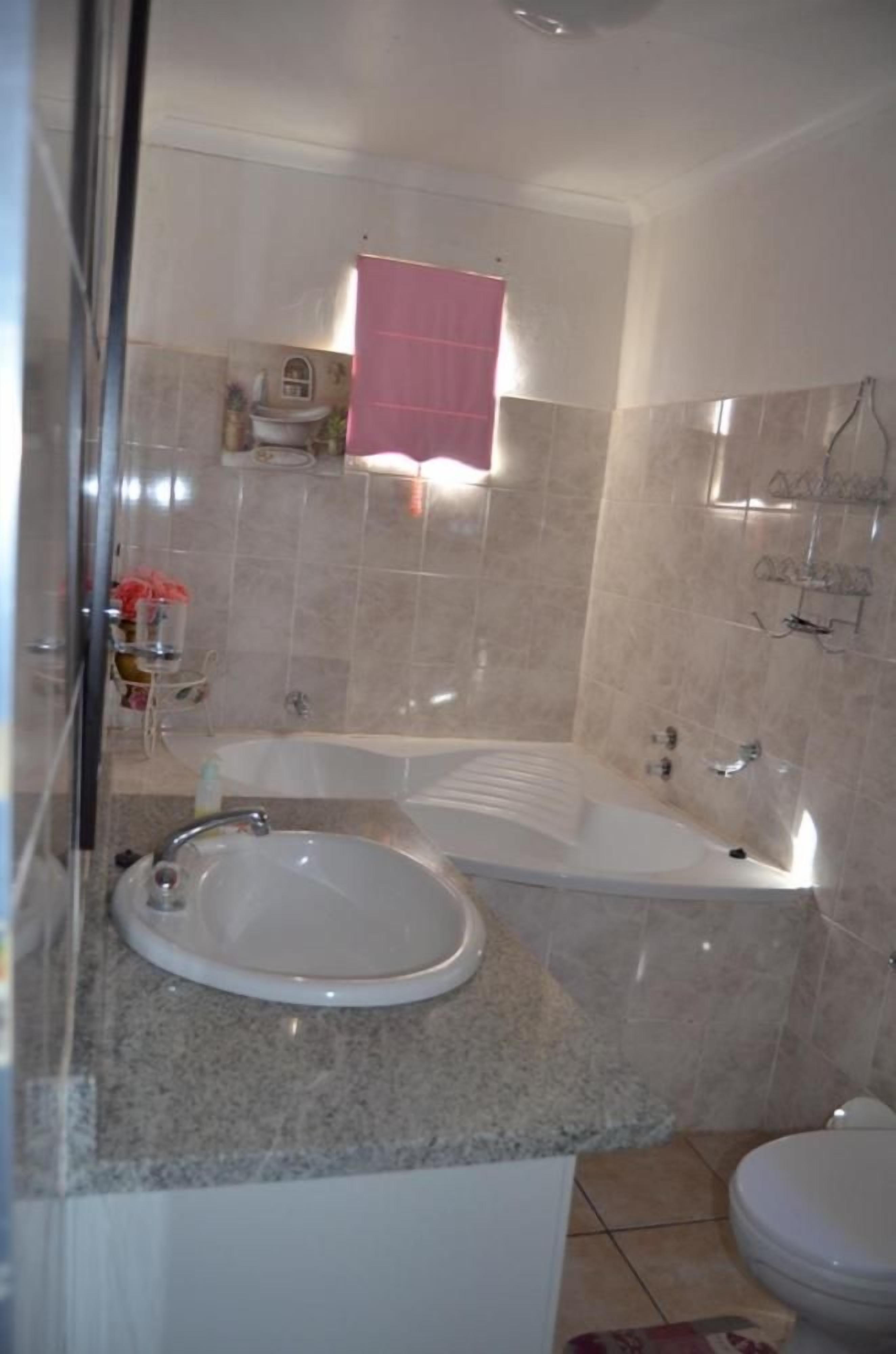 A bathroom with a bathtub, a sink, and a toilet.