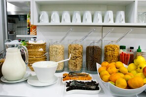 A breakfast buffet with various food items and utensils. - Infinity Ruby Hotel (Fethiye)
