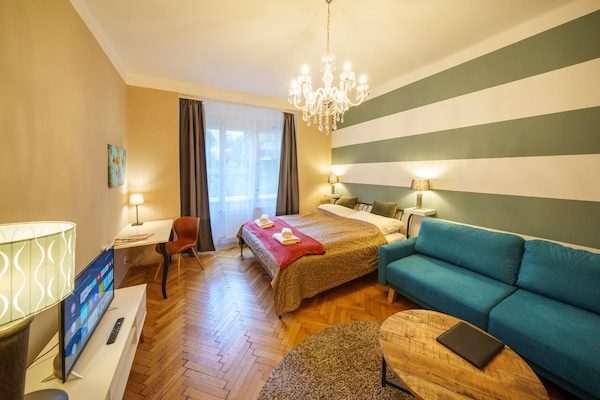 Living bedroom with double bed 180 x 200 cm, folding sofa bed and work desk