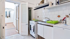 A compact kitchen with white cabinetry, a built-in oven, a microwave, and a small countertop. - GuestHost - Terrace Apartment 20 minutes from Lecce (Squinzano)