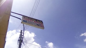 A sign for a guest house with a self-contained room and hot showers, featuring a contact number and WiFi availability. - Crestone Peak Inn Guest House (Nairobi)