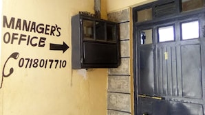 A door labeled "MANAGER'S OFFICE" with a phone number 0718017710. - Crestone Peak Inn Guest House (Nairobi)
