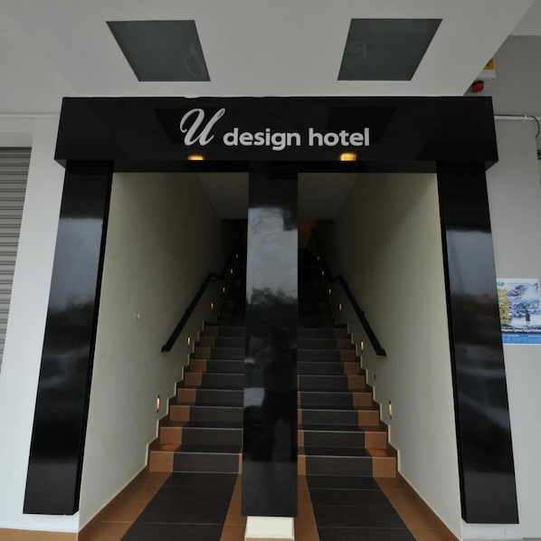 A staircase leading to a hotel entrance with a sign reading 'U design hotel'. - U Design Hotel (Temerloh)
