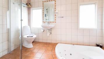 A bathroom with a glass shower enclosure, a toilet, a sink, and a bathtub.