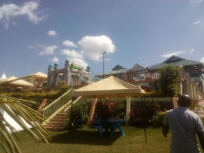 A hotel with a pool area, outdoor seating, and a staircase leading to a rooftop. - Flo Garden Resort (Ruiru)