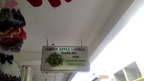 «Green Apple Lounge Nakuru» -kyltti, joka osoittaa hotellin ylellisten huoneiden sijainnin kaupungin keskustassa.