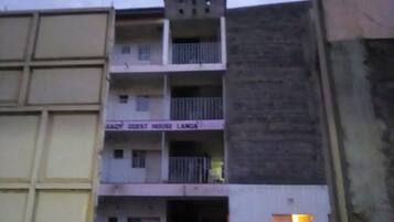 A multi-story building with a sign that reads "GUEST HOUSE LANKA".
