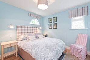 A bedroom with a bed, bedside table, lamp, window with curtains, and wall art. - The Manor Suite at Moyglare Manor (Maynooth)