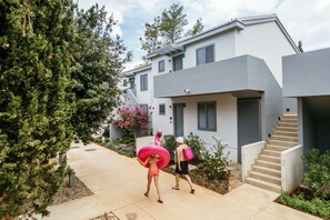 A modern building with a concrete exterior, a staircase, and a pathway leading to the entrance. - 4 * apartments / 5-6pax. (Zaton)