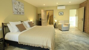 A bedroom with a bed, a chair, a door, and a staircase. - New in 2020, 5 guest rooms, tastefully decorated, ideal location! (saint remy de provence)