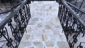 A stone staircase with metal railings.