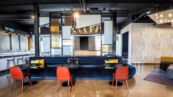 A modern bar area with seating and a counter.