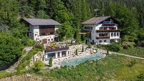 A mountain house with a swimming pool, surrounded by dense forest. - Apartment 'Baumannhof Hasental - Adults Only' with Mountain View, Shared Garden and Wi-Fi (Gfrill/Tisens bei Lana)