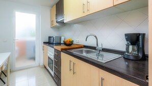 A modern kitchen with a microwave, toaster, sink, and coffee maker.