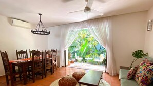 A living room with a dining area, a ceiling fan, and a view of a garden. - MARBELLA IN THE SPOTLIGHT, near the beach, for an effortlessly warm stay.  (Villa Las Flores)