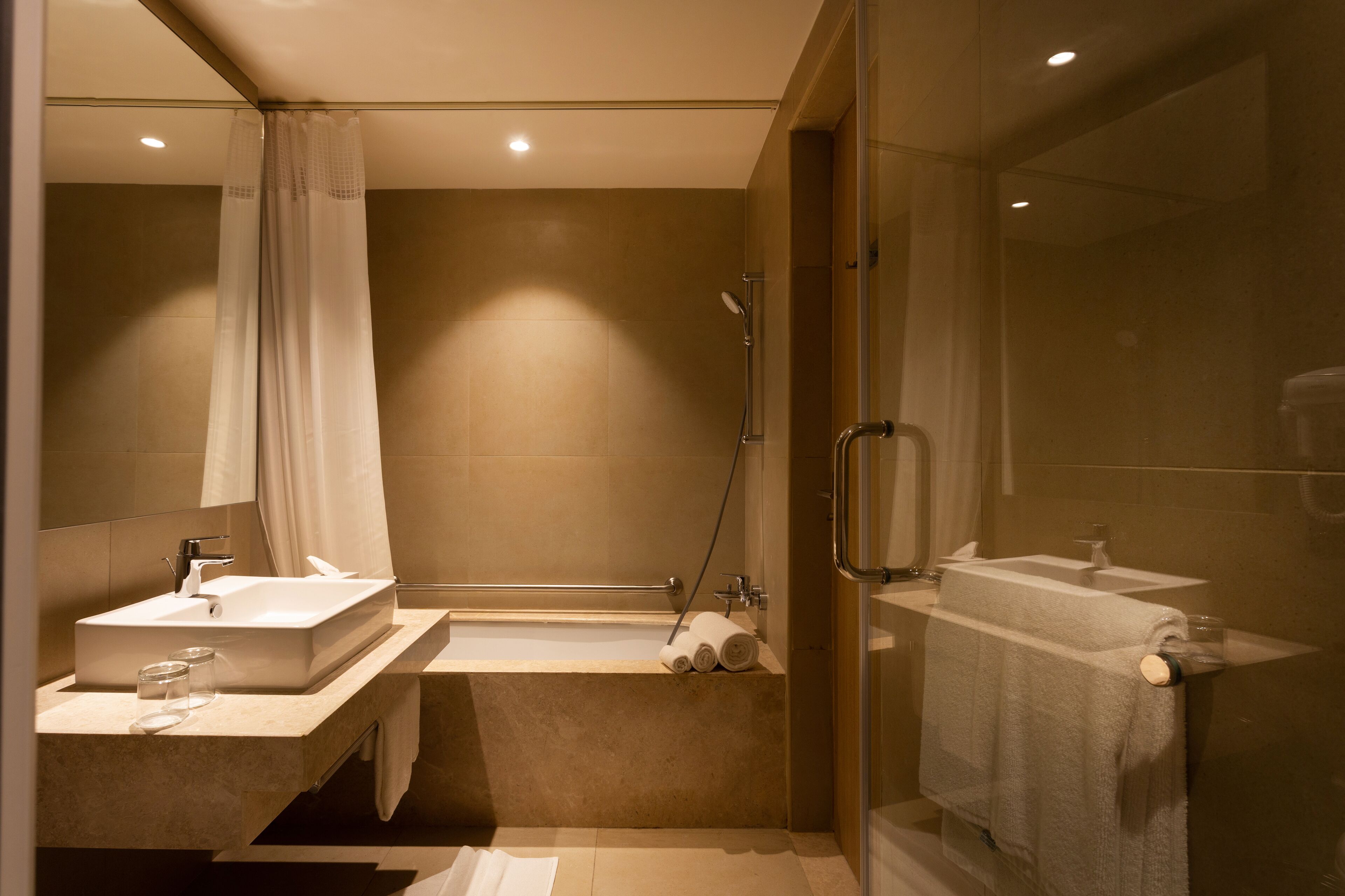 suite, 1 queen bed, bathtub (two bay) | bathroom | shower, hydromassage showerhead, hair dryer, slippers
