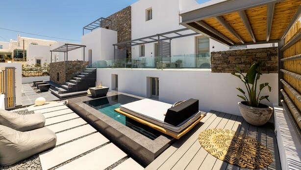 A modern outdoor living area with a pool, lounge chairs, and a pergola. - Parion Opus - Adults Only (Paros)