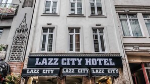 A multi-story building with a sign reading "LAZZ CITY HOTEL" at the ground level. - Lazz City Hotel (Istanbul)