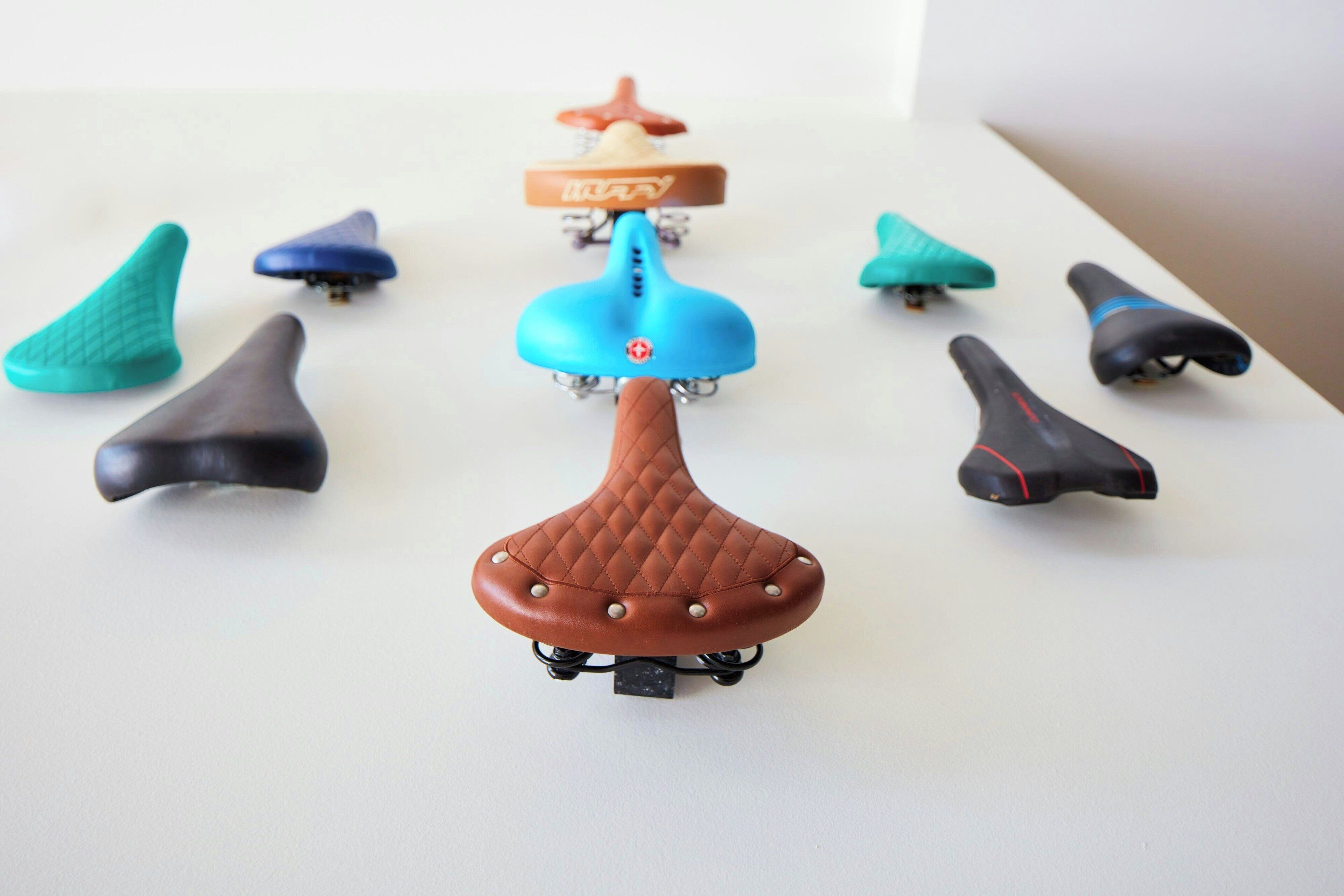 A collection of scooter seats in various colors and designs.