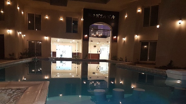 A swimming pool with a reflection of the building's interior, including a visible entrance labeled "MONTANA". - Montana Connection, Hurghada (Hurghada)