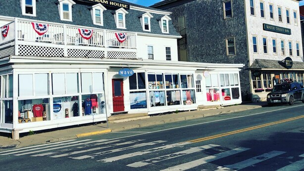 A waterfront building with a sign reading "New Shoreham House" and another sign for "Water Street Inn".