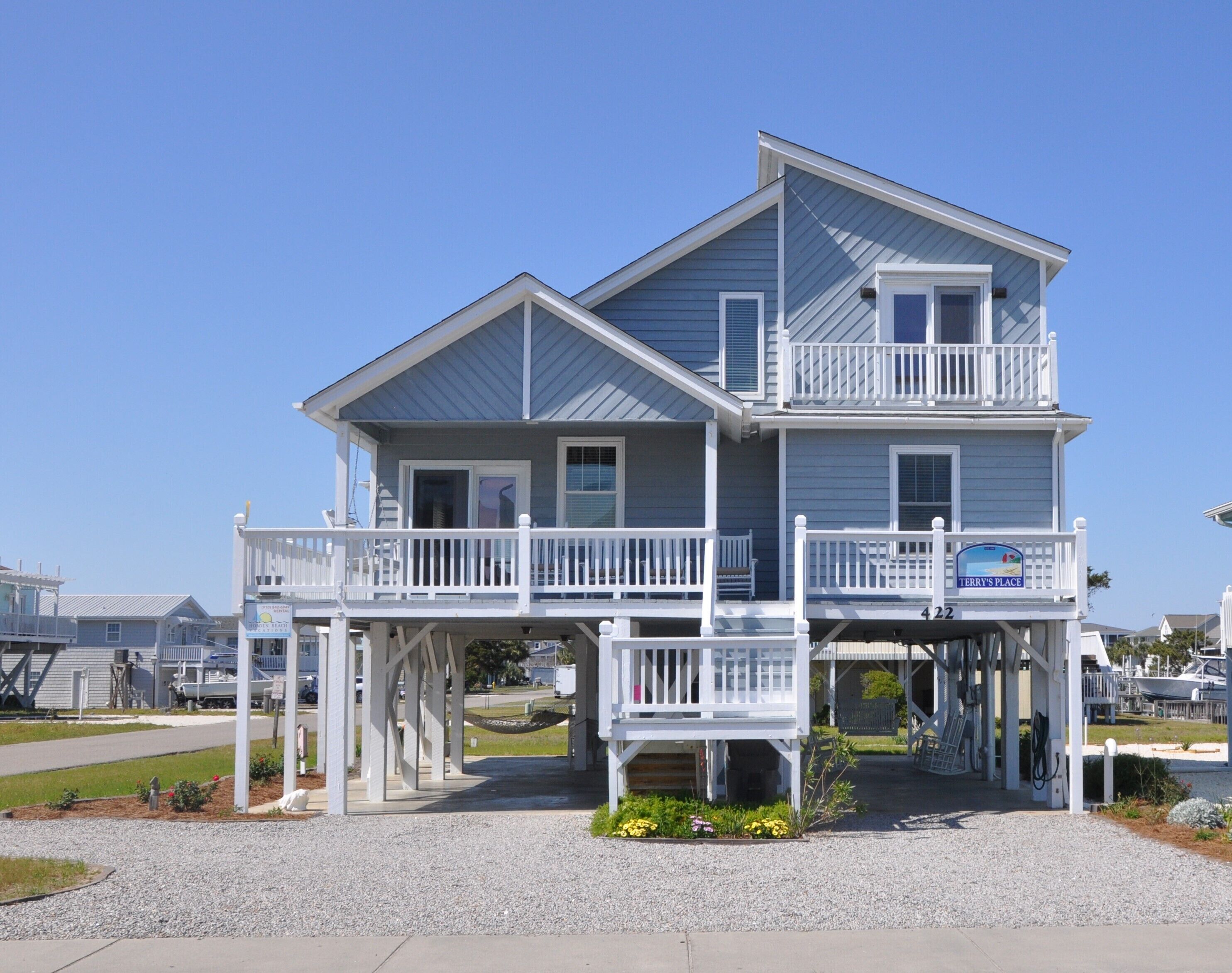 A two-story house with a balcony and a sign that reads "Terry's Place".