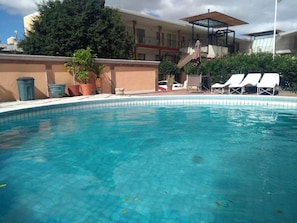Outdoor pool, open 9:00 AM to 9:00 PM, pool loungers