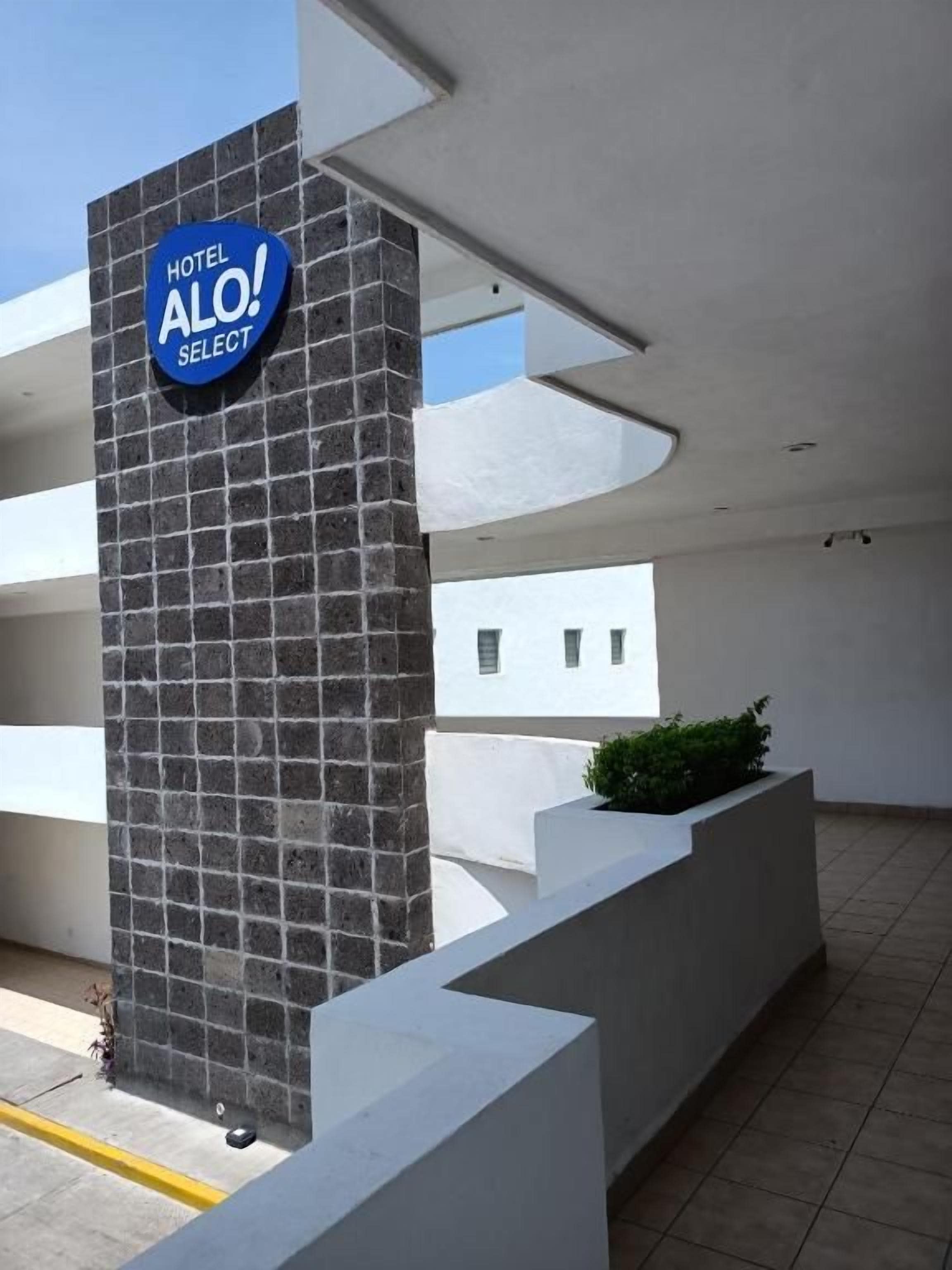 A modern hotel entrance with a prominent sign reading 'HOTEL ALO! SELECT'.