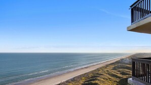 A coastal view with a beach and ocean.