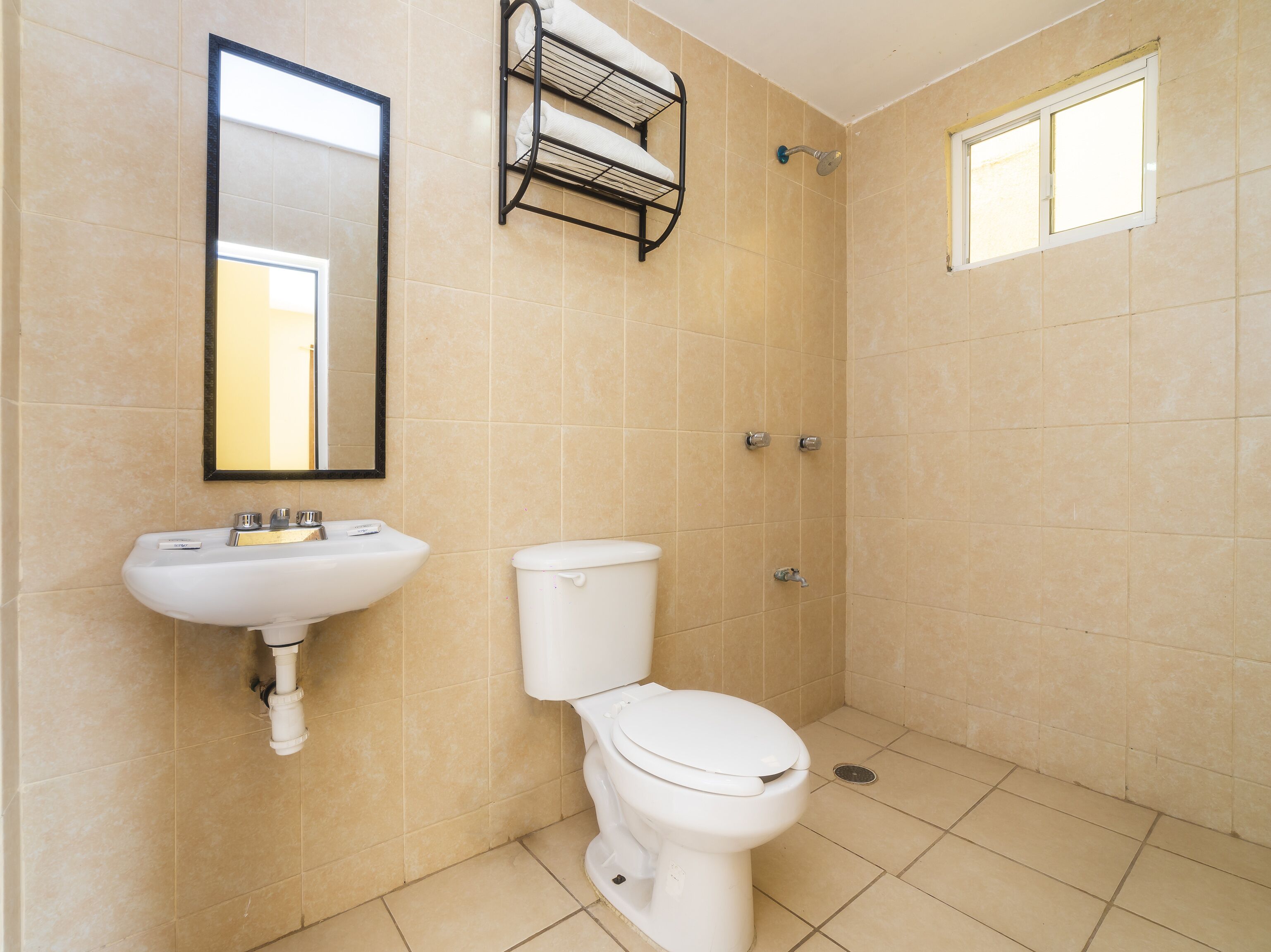 A bathroom with a sink, toilet, and shower.