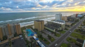 A coastal hotel with multiple buildings, a swimming pool, and a view of the ocean. - Crystal Tower 609 (Gulf Shores)