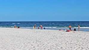 A beach with people and beach equipment.
