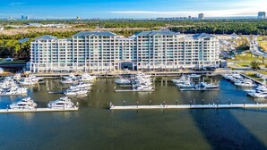 A large hotel with multiple floors and a marina with numerous boats.