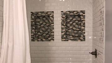 Combined shower/bathtub, towels, soap, toilet paper