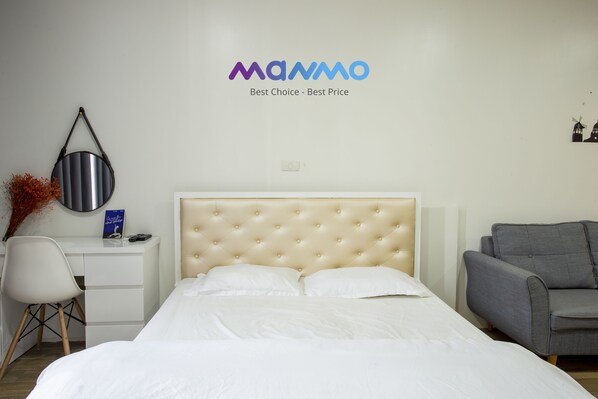 Relax in a spacious room with a large bed, desk, and sofa, perfect for unwinding.