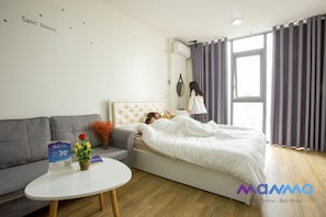 Relax in a comfortable room with a tufted headboard, sofa, and small table.