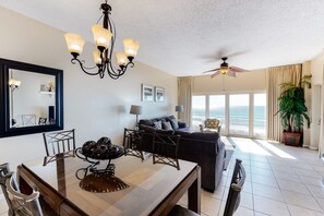 Enjoy meals with family and friends at the dining table, surrounded by a comfortable sofa and ocean views.