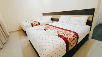 A hotel room with two beds, a wooden headboard, and a tiled floor.