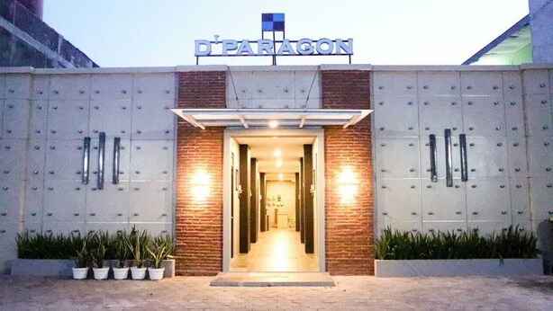 The entrance to D'Paragon hotel with a brick facade and a metal gate. - D'Paragon Beo (Depok)