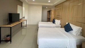 A hotel room with two beds, a TV on a wooden table, and a wardrobe. - Gassan Panorama Golf Club (Ban Thi)