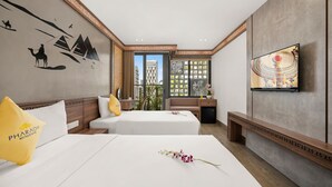 A hotel room with two beds, a TV, a decorative wall, and a view of a building outside. - Pharaoh Boutique Hotel Danang (Da Nang)