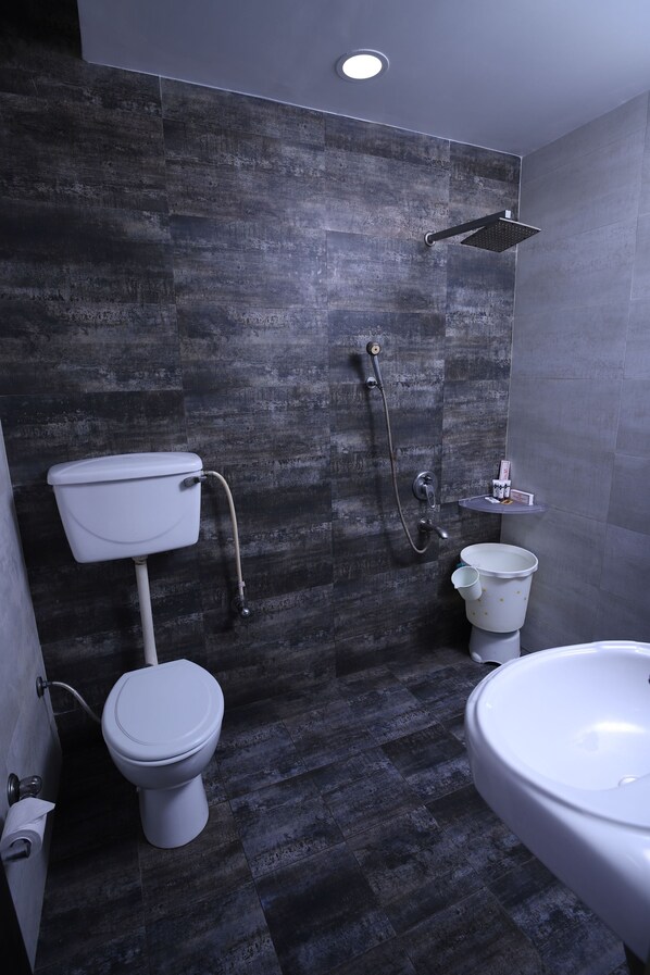 A modern bathroom with a toilet, bidet, and sink.