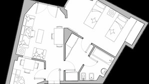 Plànol d'un hotel amb diverses habitacions, un vestíbul central i una zona d'aparcament.