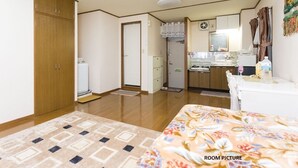 A room with a bed, a small kitchenette, a bathroom, and a wardrobe. - Centrally Located Deluxe Furnished.3 (Tokyo)