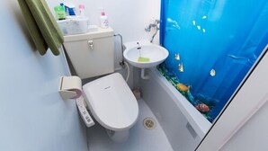 A bathroom with a toilet, sink, and a large window with an underwater scene. - Centrally Located Deluxe Furnished.4 (Tokyo)