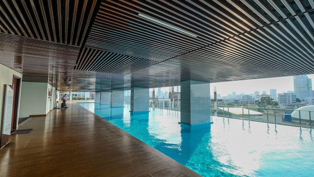 An indoor swimming pool with a wooden floor and a city view. - Wonderful 2BR at Menteng Park Apartment (Jakarta)