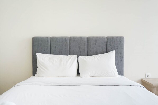 Restful retreat with a neatly made bed and crisp white linens.